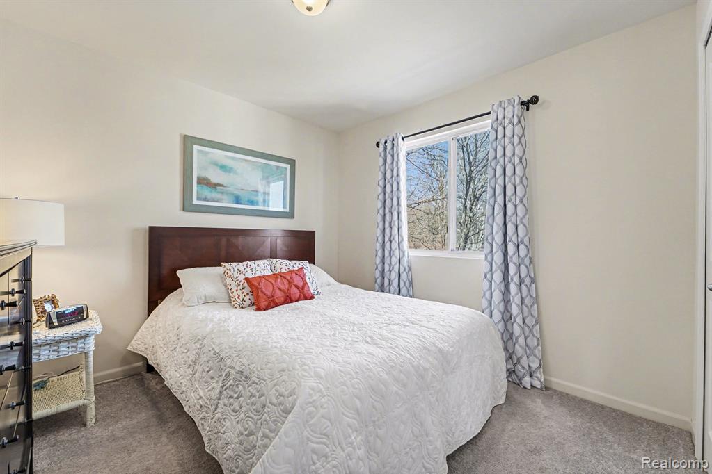 Carpeted bedroom featuring baseboards
