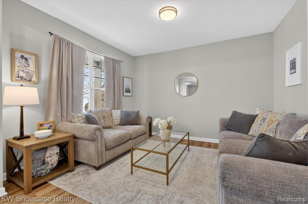 Living area featuring recessed lighting, a fireplace, light wood finished floors, and a ceiling fan