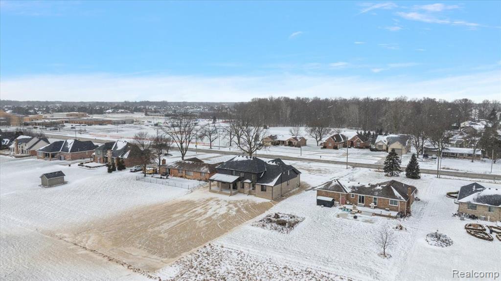 Snowy aerial view with a residential view