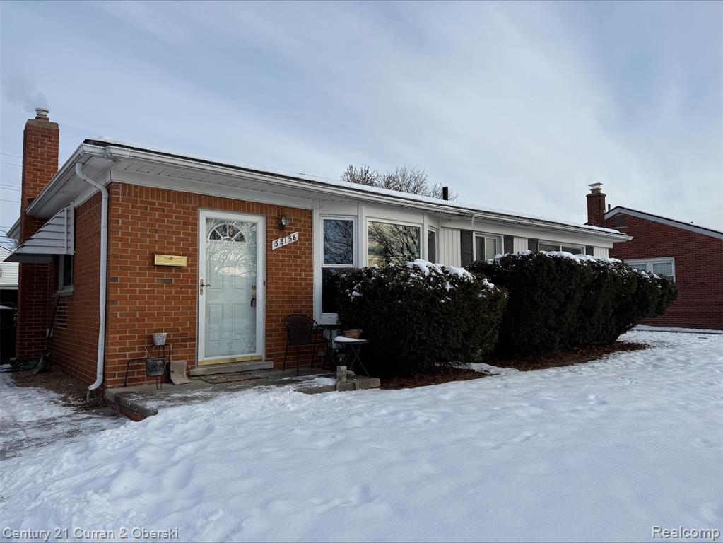 Photo for 35158 Parkdale Street, Livonia, MI 48150 - Listing #20251052910 View of front of house featuring brick siding, a chimney, and entry steps