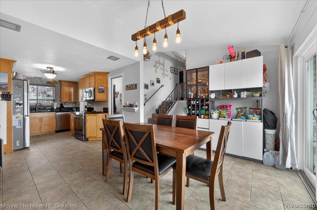 Dining space with light tile patterned floors