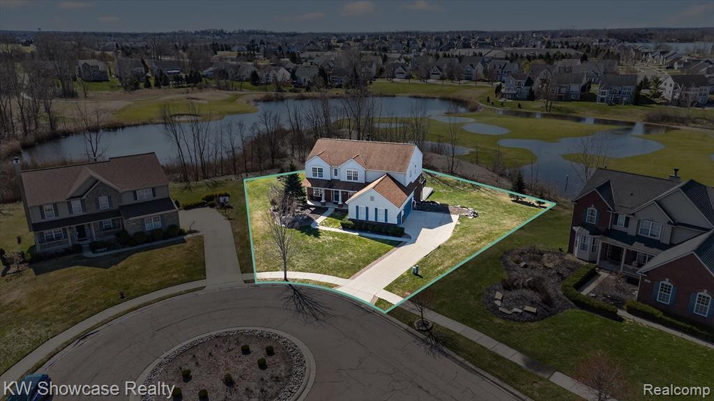 Aerial perspective of suburban area featuring a nearby body of water and property parcel outlined