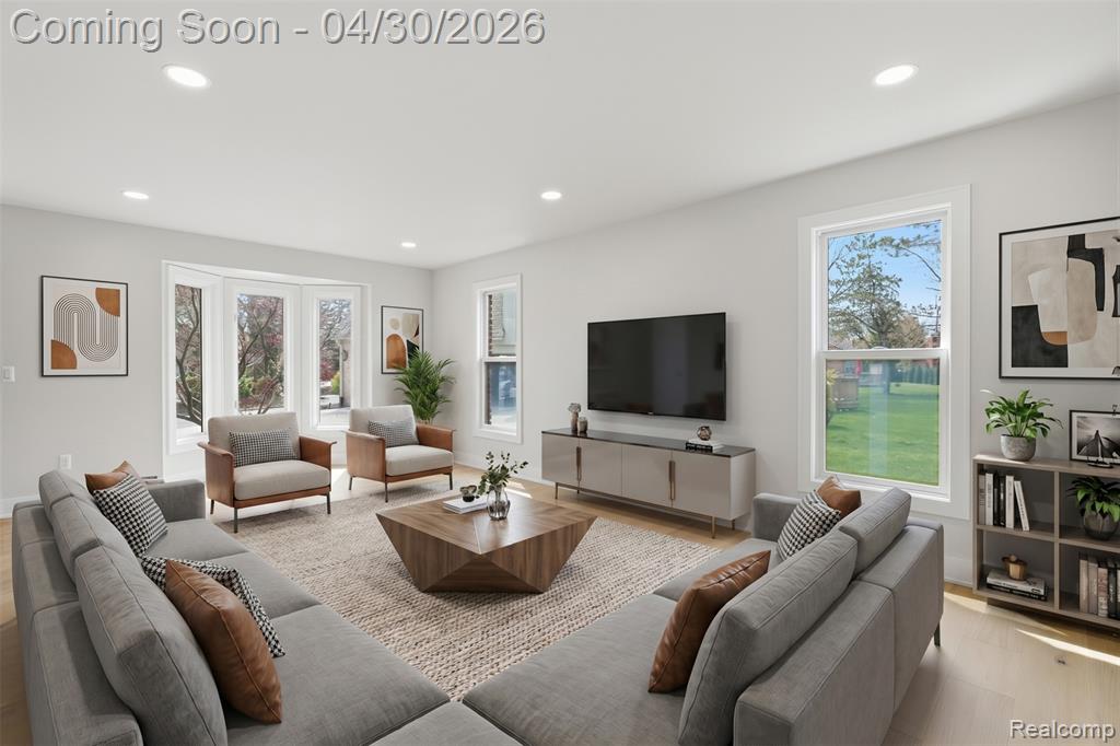 Living area with recessed lighting, plenty of natural light, and light wood finished floors