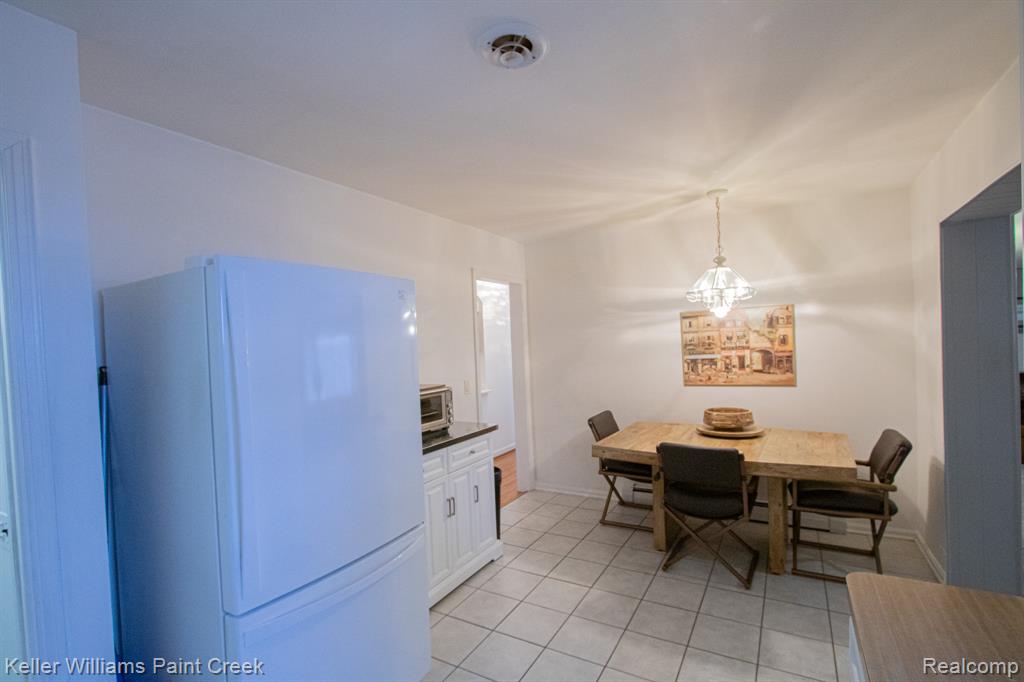 Dining room featuring light tile patterned flooring and baseboards