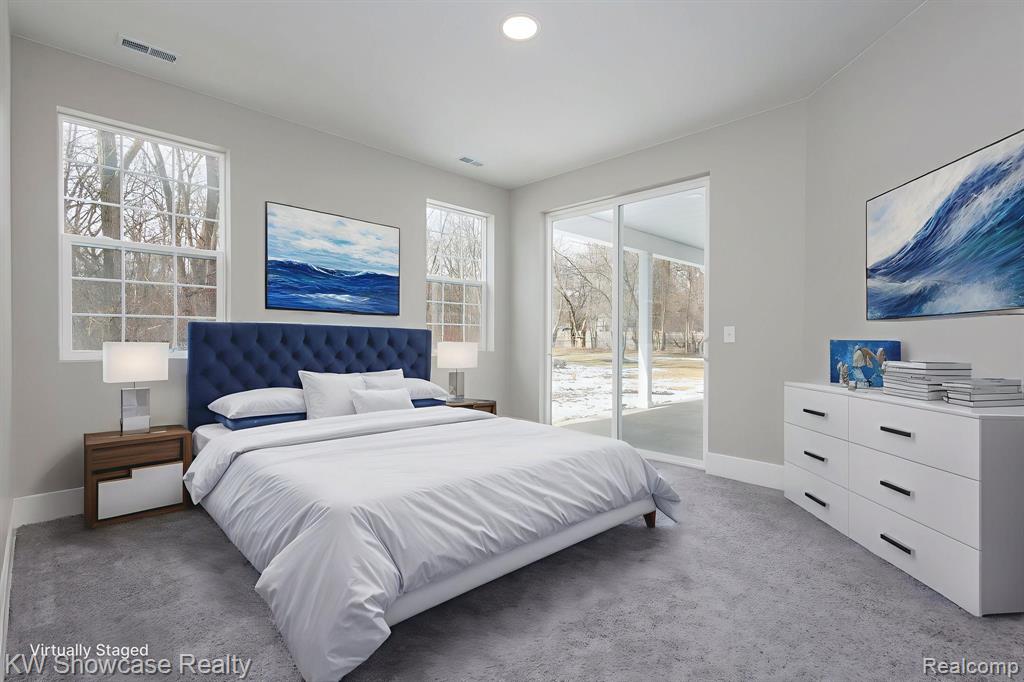 Primary Bedroom with light carpet, access to exterior, and recessed lighting.