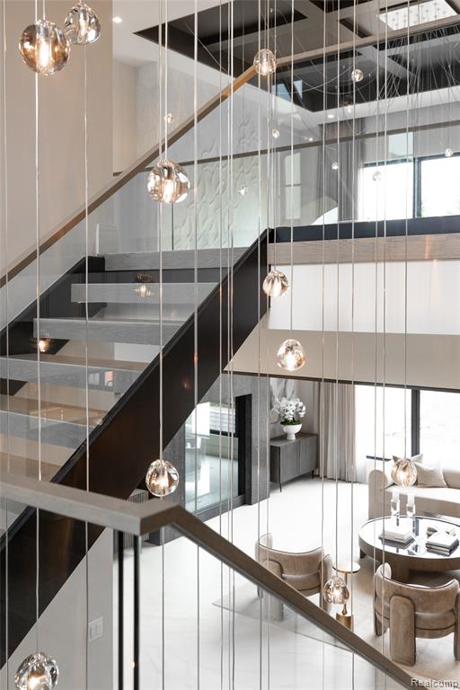 Stairs featuring a chandelier