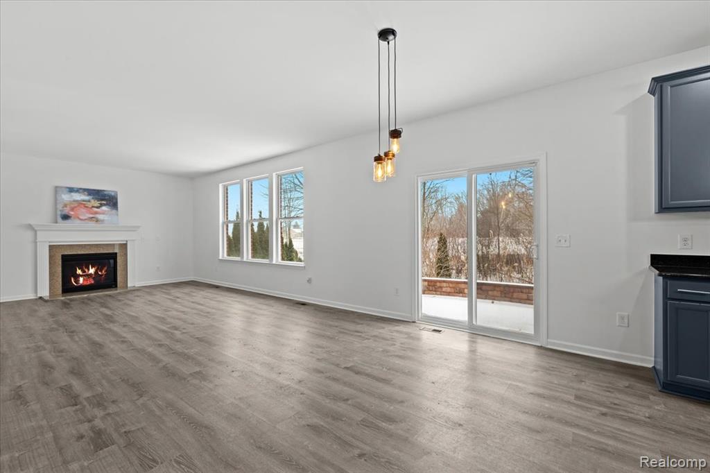 Carpeted spare room featuring baseboards