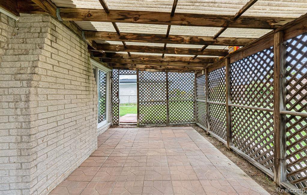 Unfurnished sunroom featuring a patio area