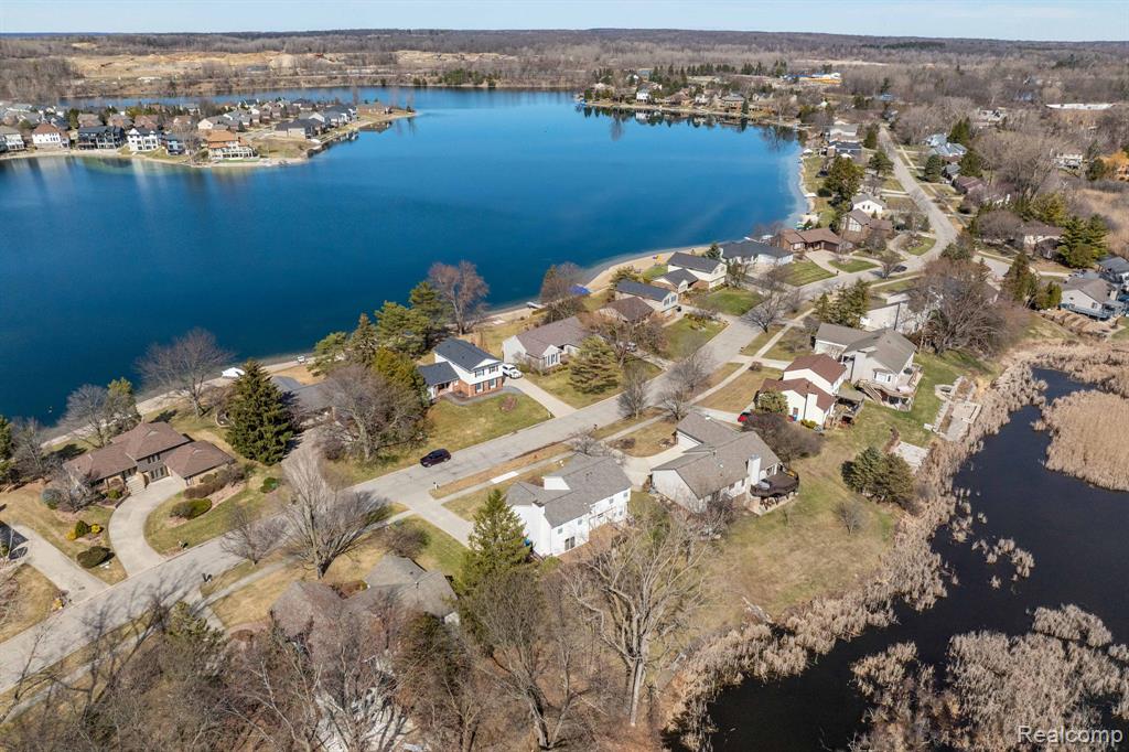 Aerial view of residential area featuring a large body of water