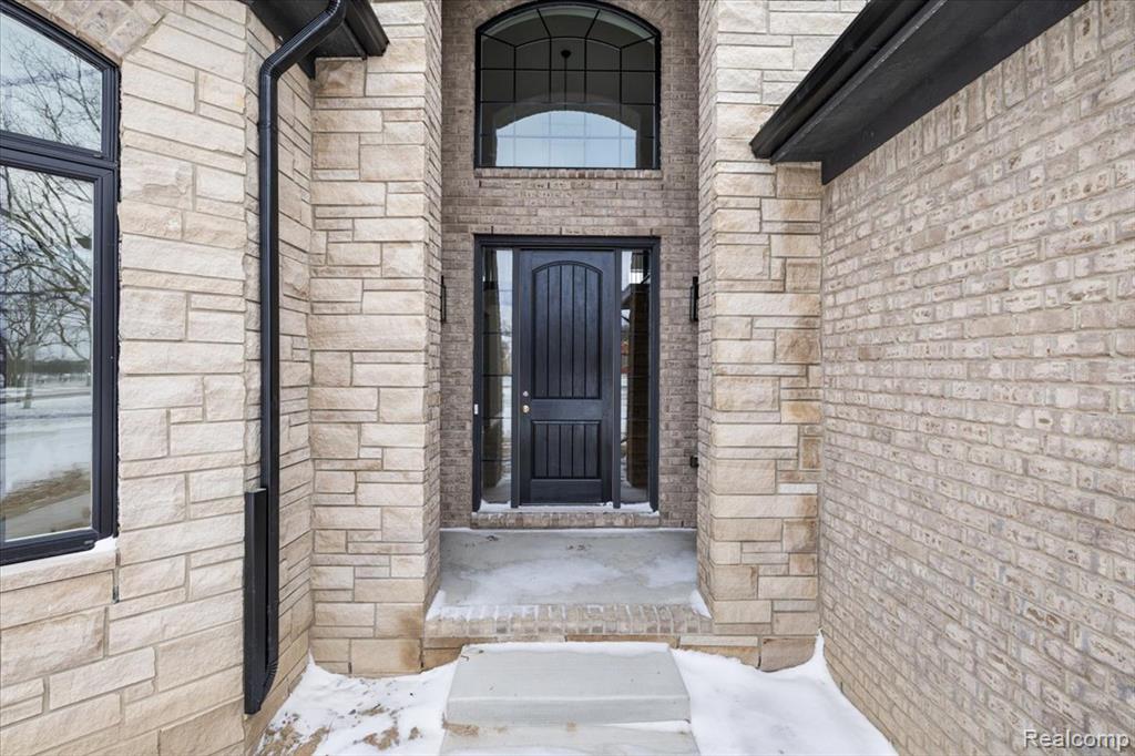 Property entrance featuring stone siding