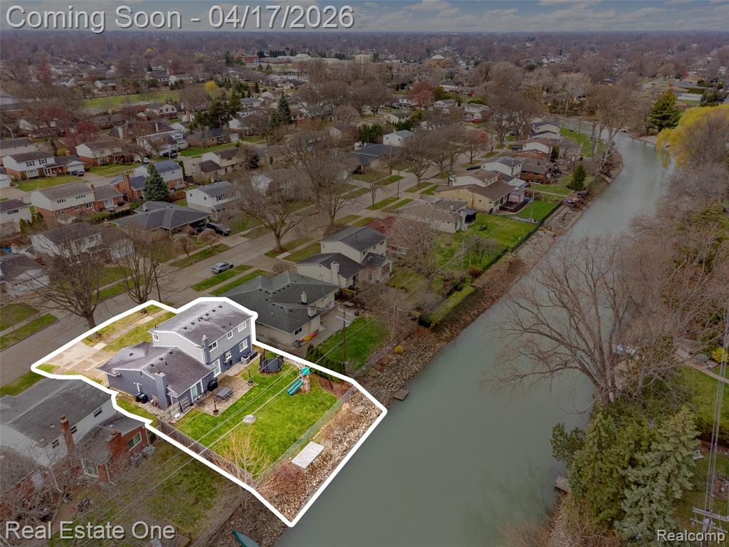 Aerial perspective of suburban area with a nearby body of water