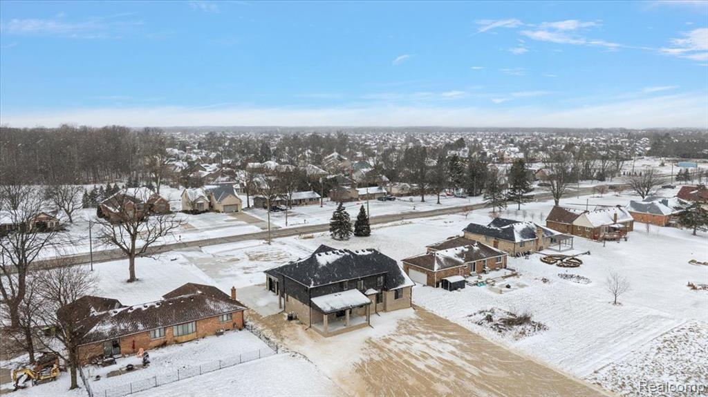 Snowy aerial view with a residential view