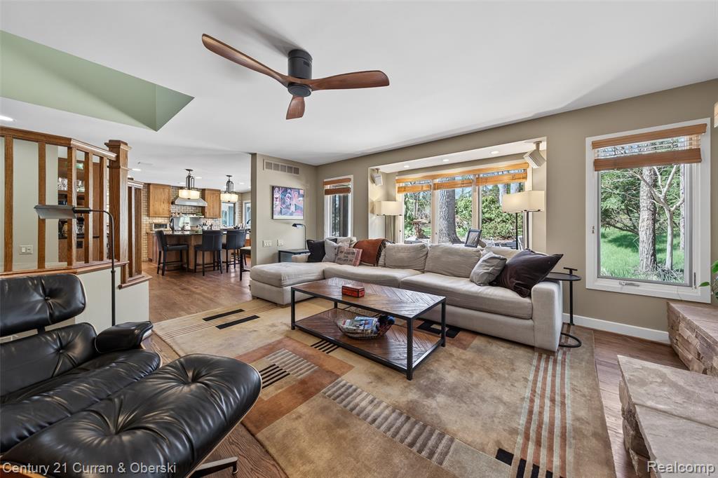 Living room featuring wood finished floors and ceiling fan