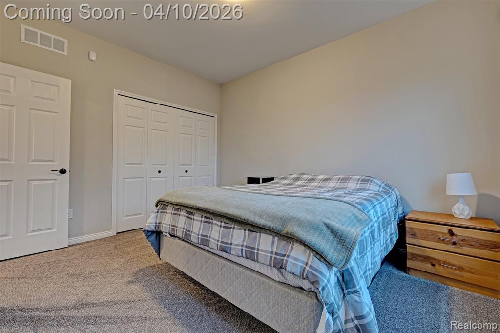 Bedroom with carpet floors and a closet