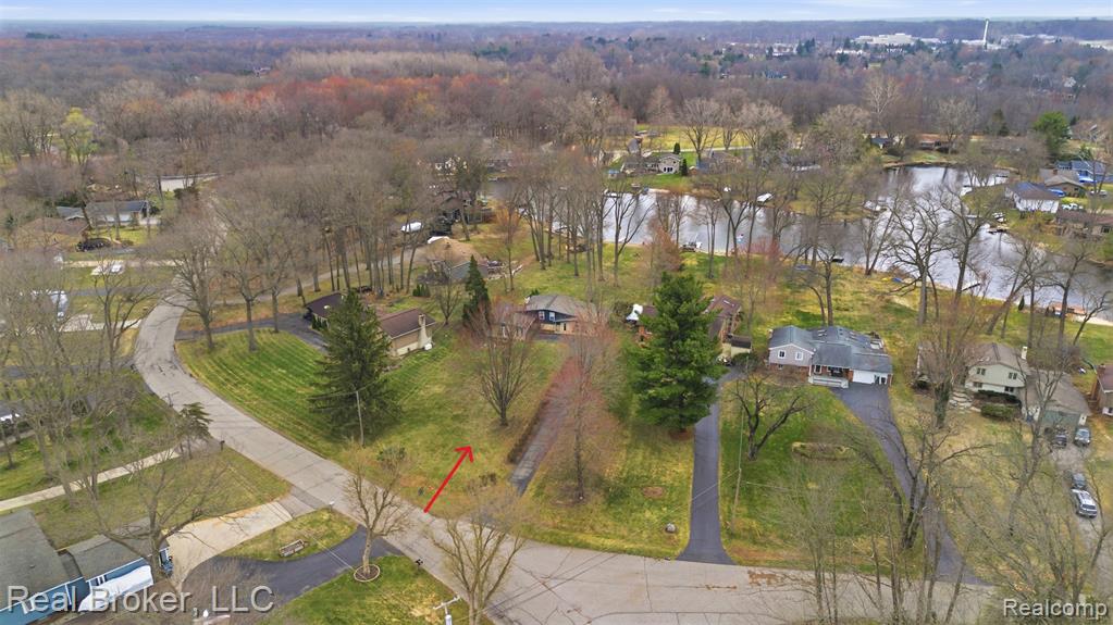 Aerial view of residential area featuring a nearby body of water
