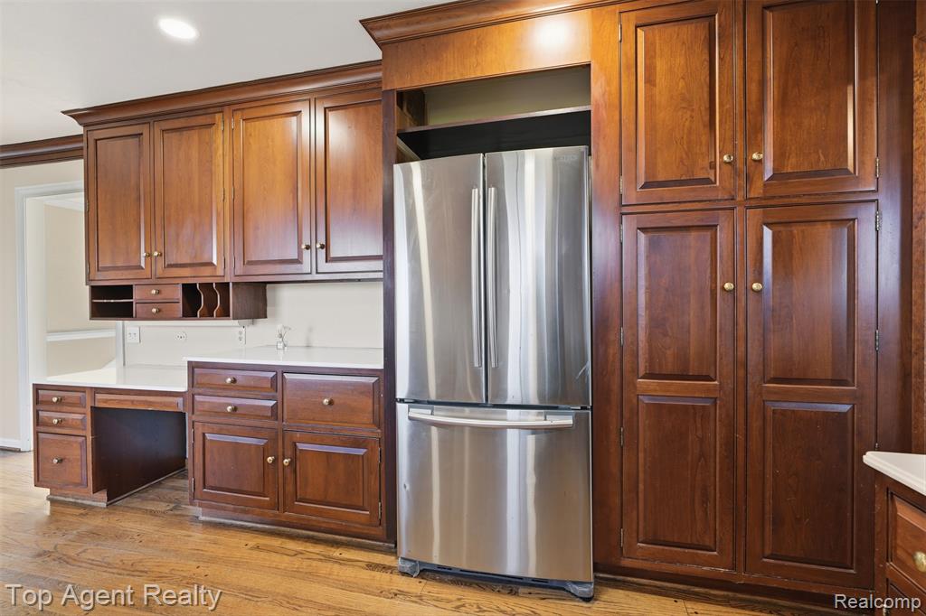 Kitchen featuring crown molding, electric range, light wood-type flooring, stainless steel dishwasher, and tasteful backsplash