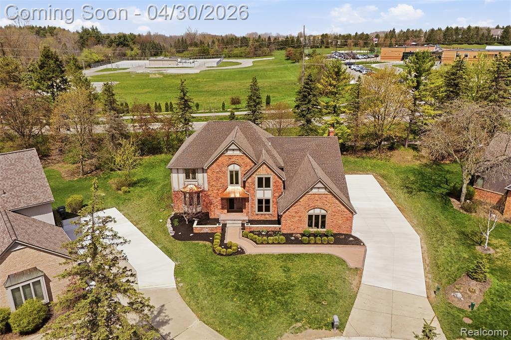 View from above of property featuring a tree filled landscape