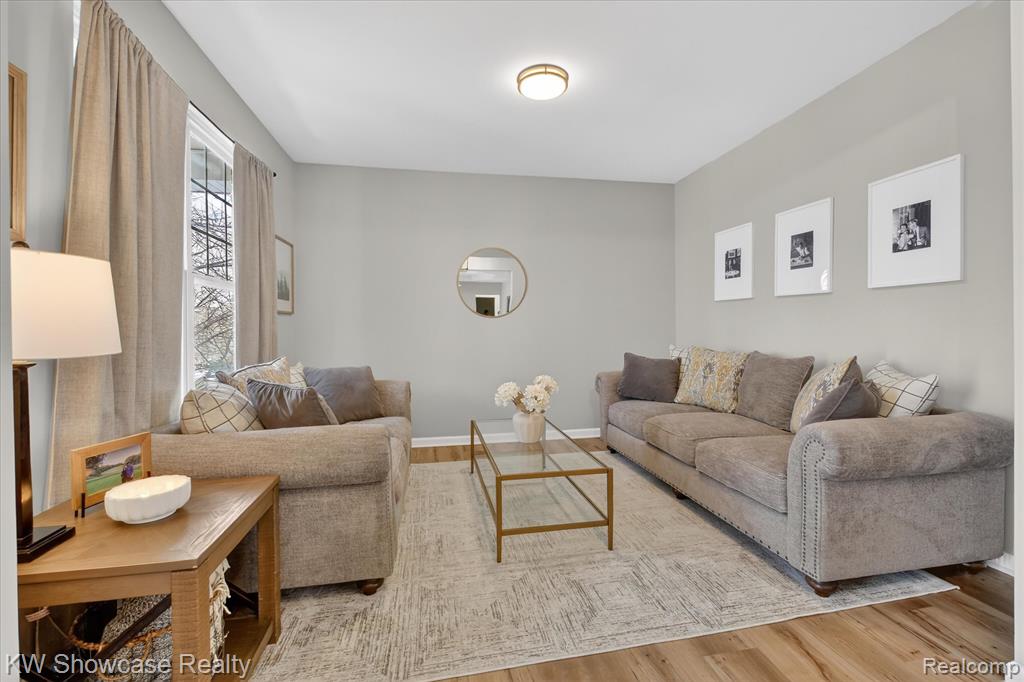 Living area featuring recessed lighting, light wood-style flooring, a fireplace, stairs, and ceiling fan