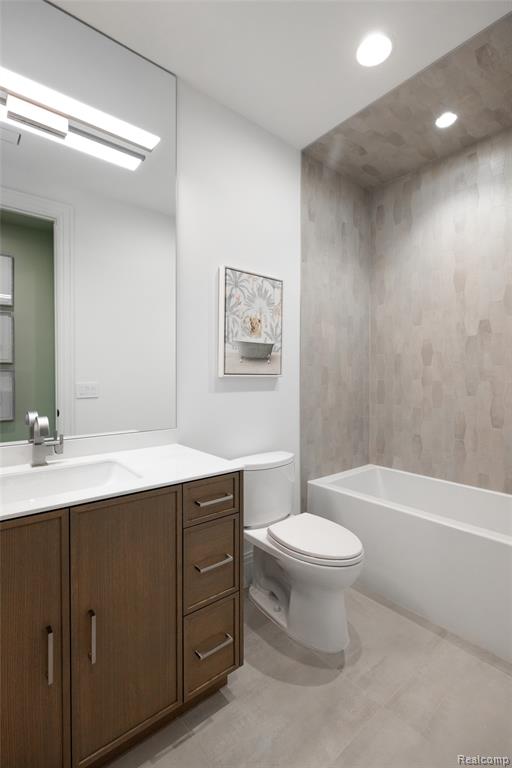 Bathroom with vanity, light tile patterned floors, bathing tub / shower combination, and recessed lighting