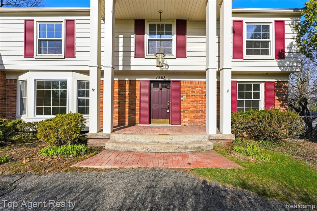 Doorway to property with brick siding