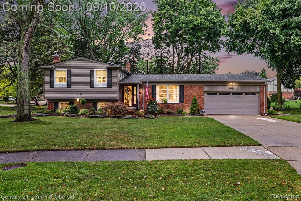 Brick and siding exterior with mature trees