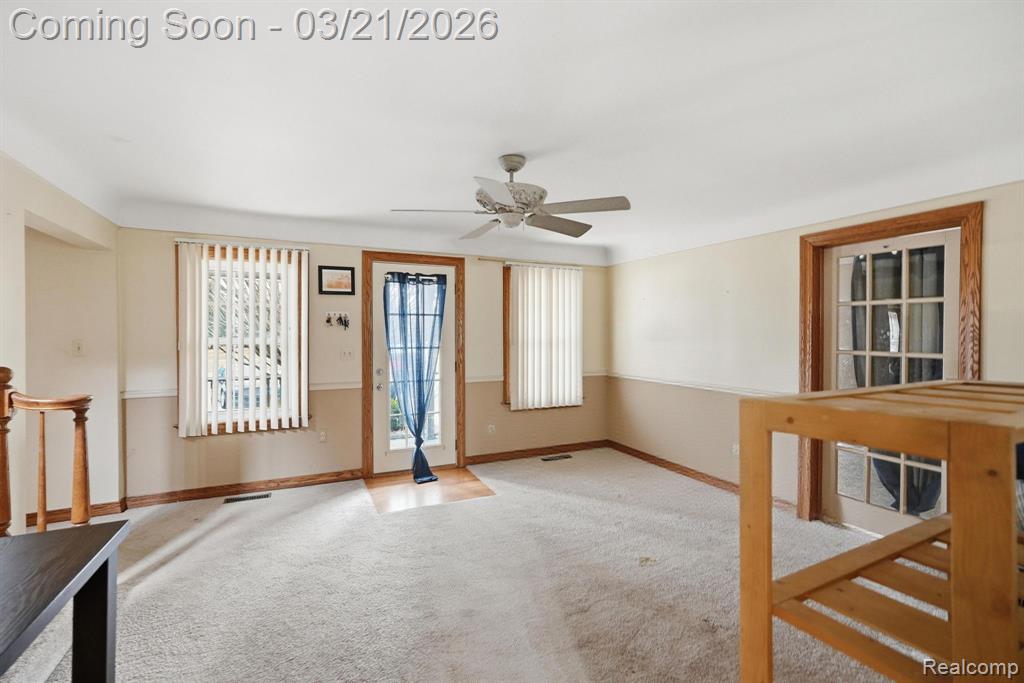 Spare room featuring a ceiling fan and carpet floors