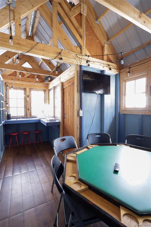 Rec room with dark wood-style flooring