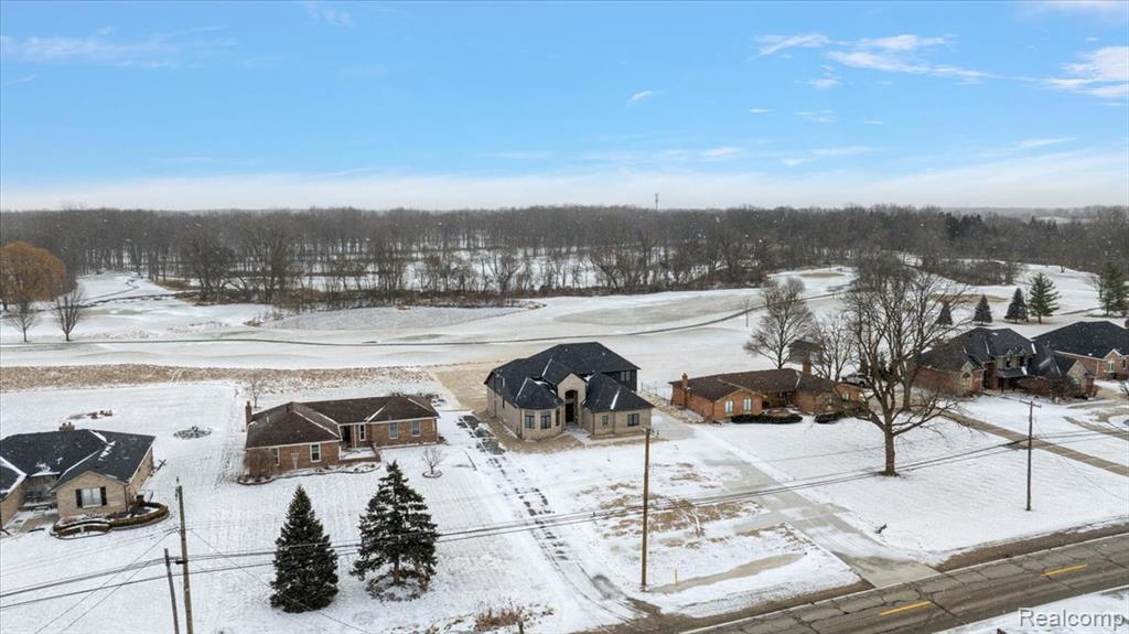 Snowy aerial view featuring a residential view