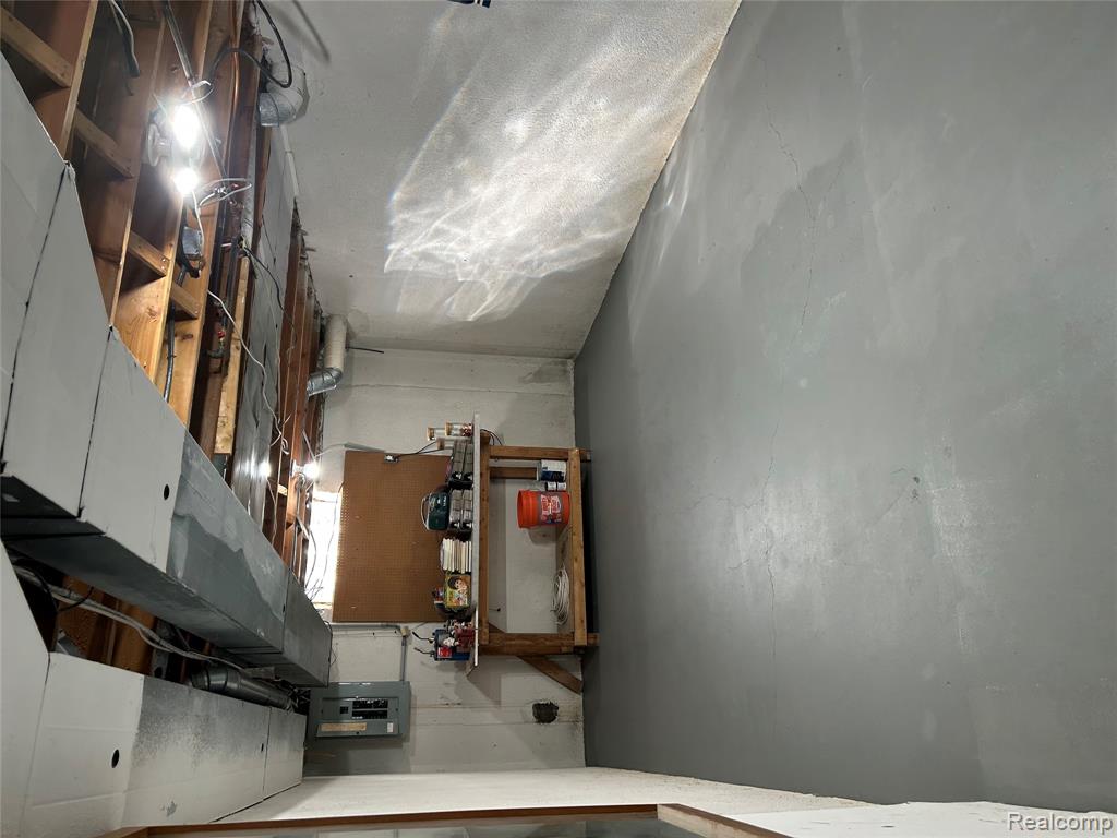 Unfinished basement with electric panel