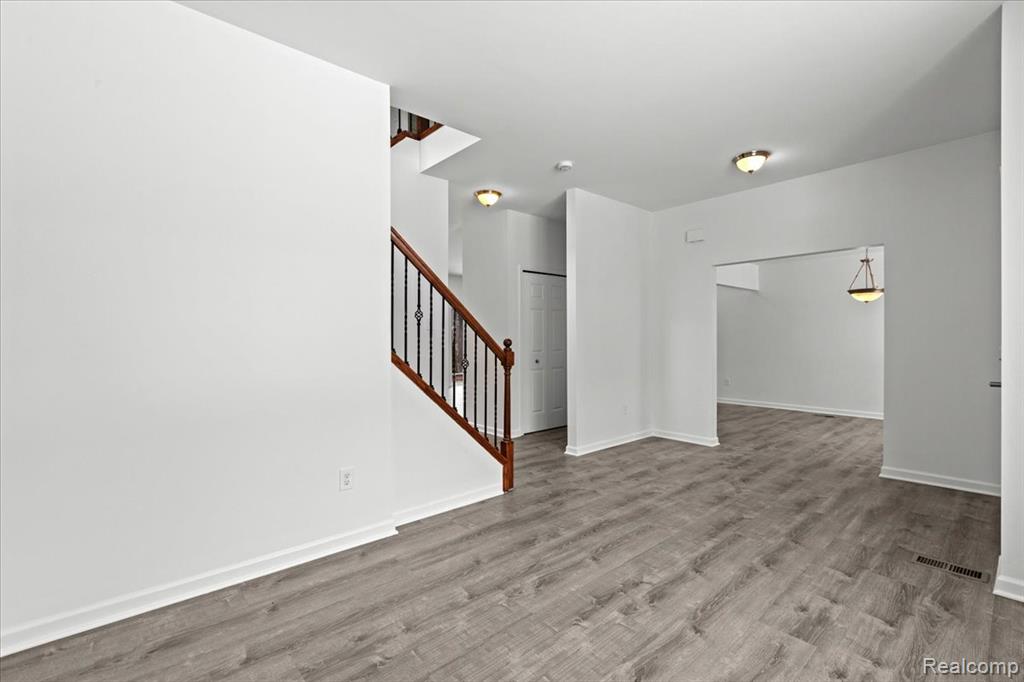 Carpeted living area featuring baseboards