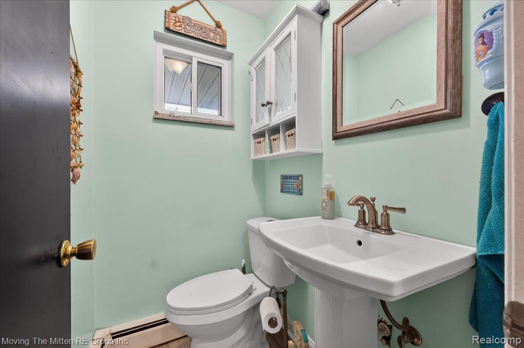 Bathroom with toilet and a baseboard radiator