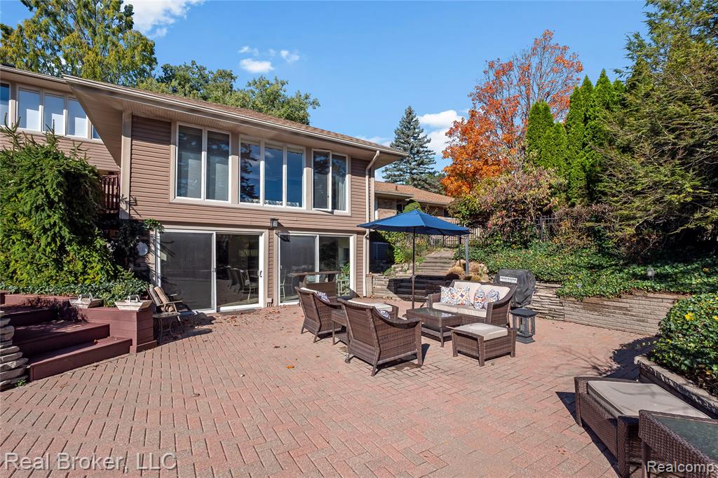 View of pool featuring a fenced backyard, an in-ground hot tub, and an outbuilding