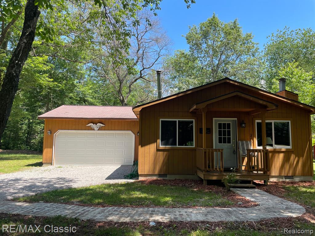 View of side of home with crawl space, a chimney, and roof with shingles