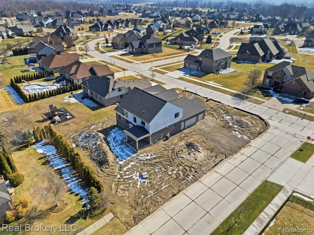 Aerial overview of property's location featuring nearby suburban area