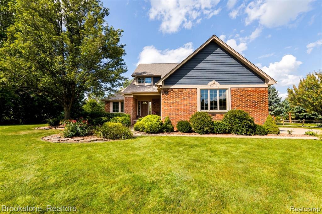 Brick and siding exterior with mature landscaping