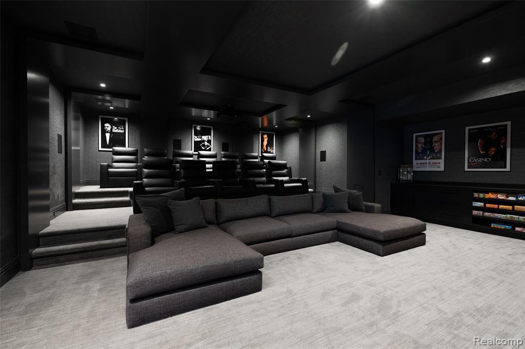 Carpeted home theater featuring a tray ceiling and recessed lighting