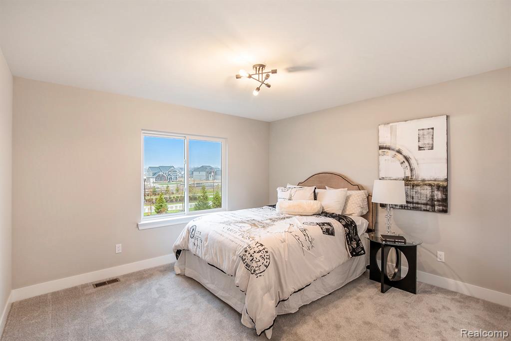 Carpeted bedroom featuring baseboards