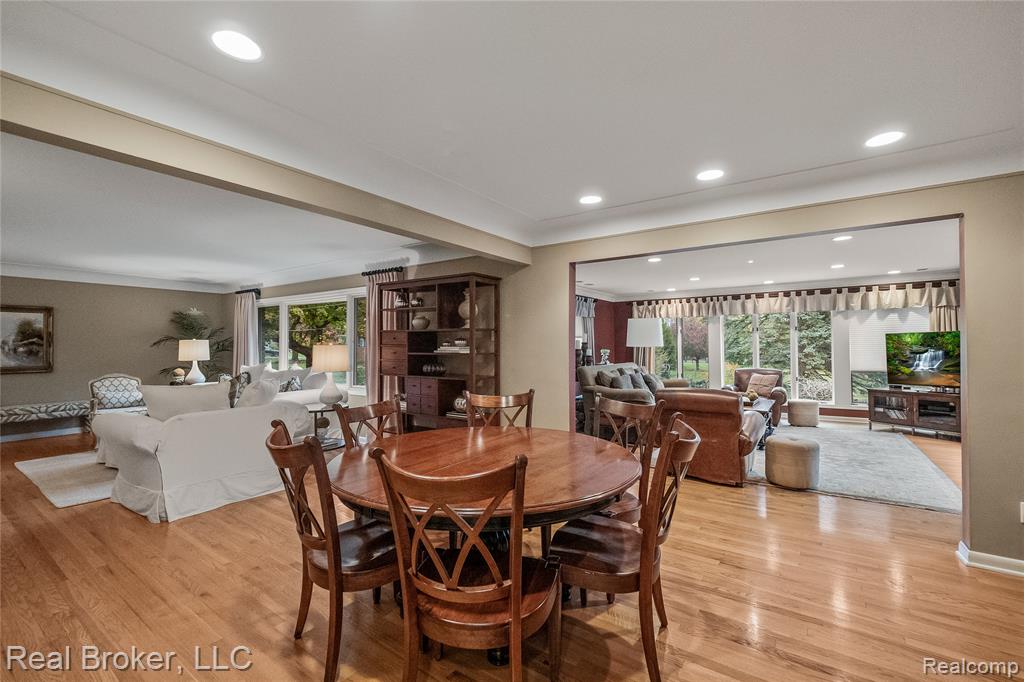 Living room featuring light wood finished floors, plenty of natural light, and a fireplace