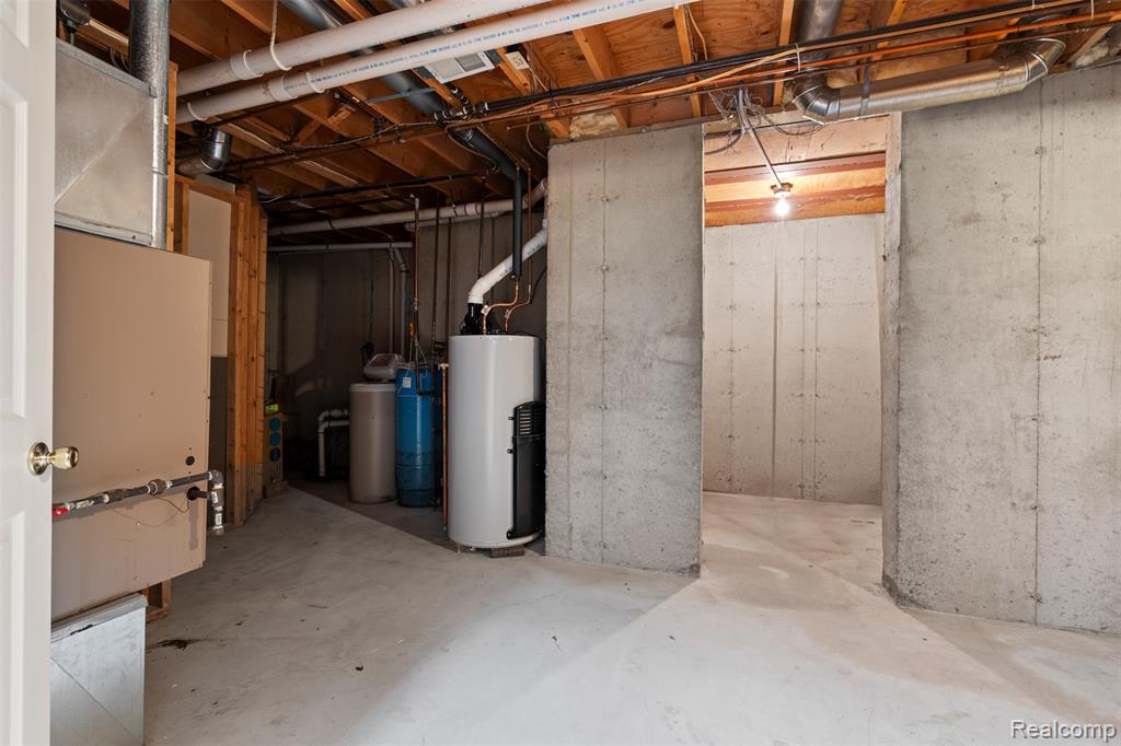 Unfinished basement with water heater, a water softener, and heating unit