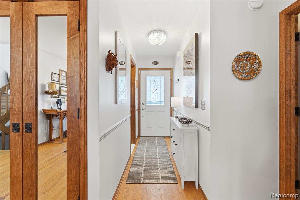 Doorway featuring wood finished floors and stairs