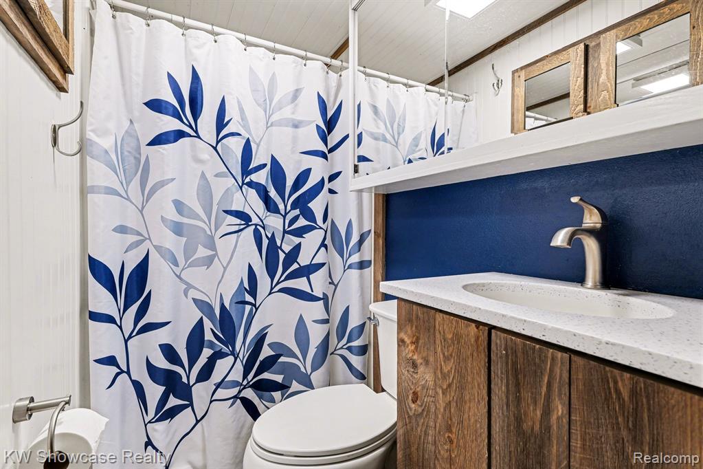 Full bathroom with vanity and a shower with shower curtain