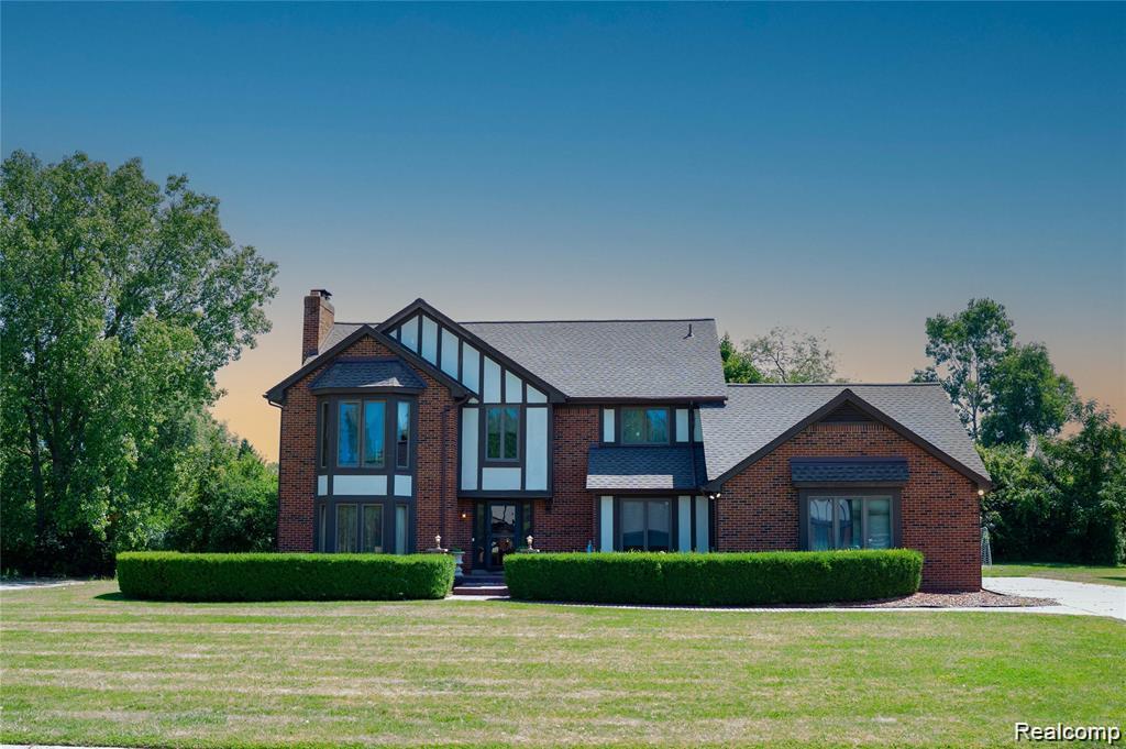 Brick and timber-frame exterior featuring a prominent bay window