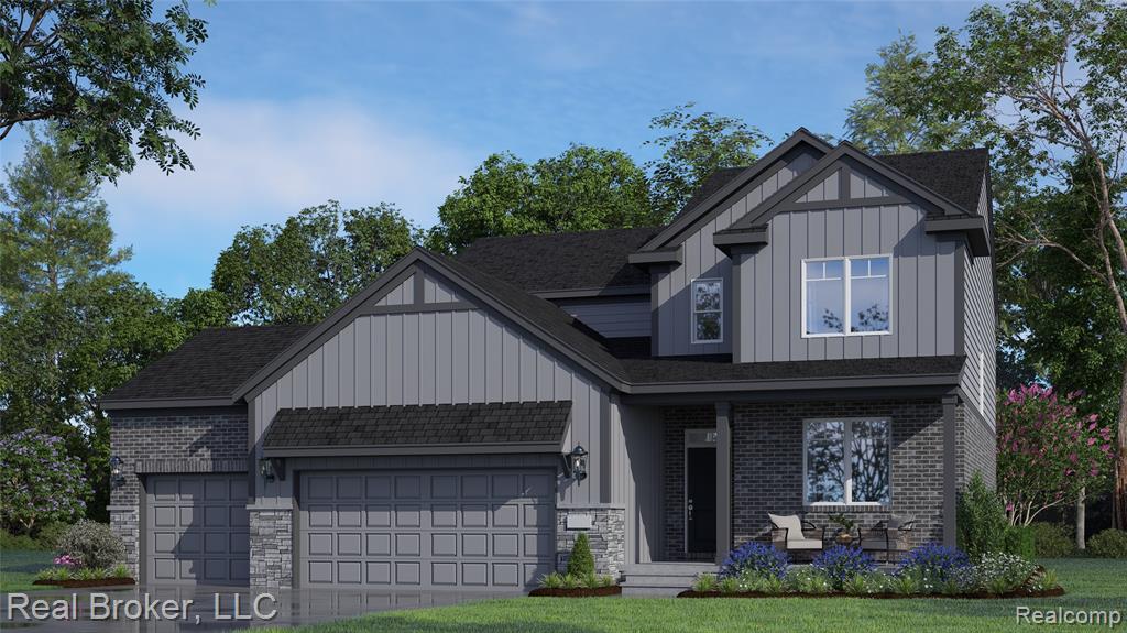 View of front facade featuring board and batten siding, an attached garage, driveway, and a front yard