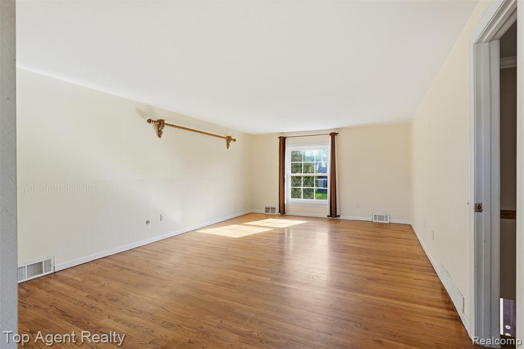 Spare room with light wood-style flooring and baseboards