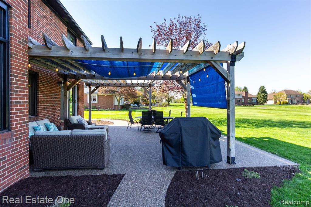 View of patio featuring a pergola, area for grilling, and an outdoor living / dining area