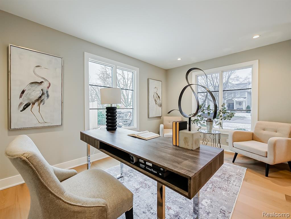 Home office featuring light wood-style flooring, healthy amount of natural light, and recessed lighting