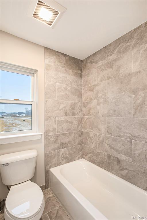Full bath with tub / shower combination and tile patterned floors