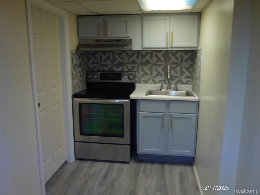 Bathroom with a tile shower, double vanity, and tile patterned floors