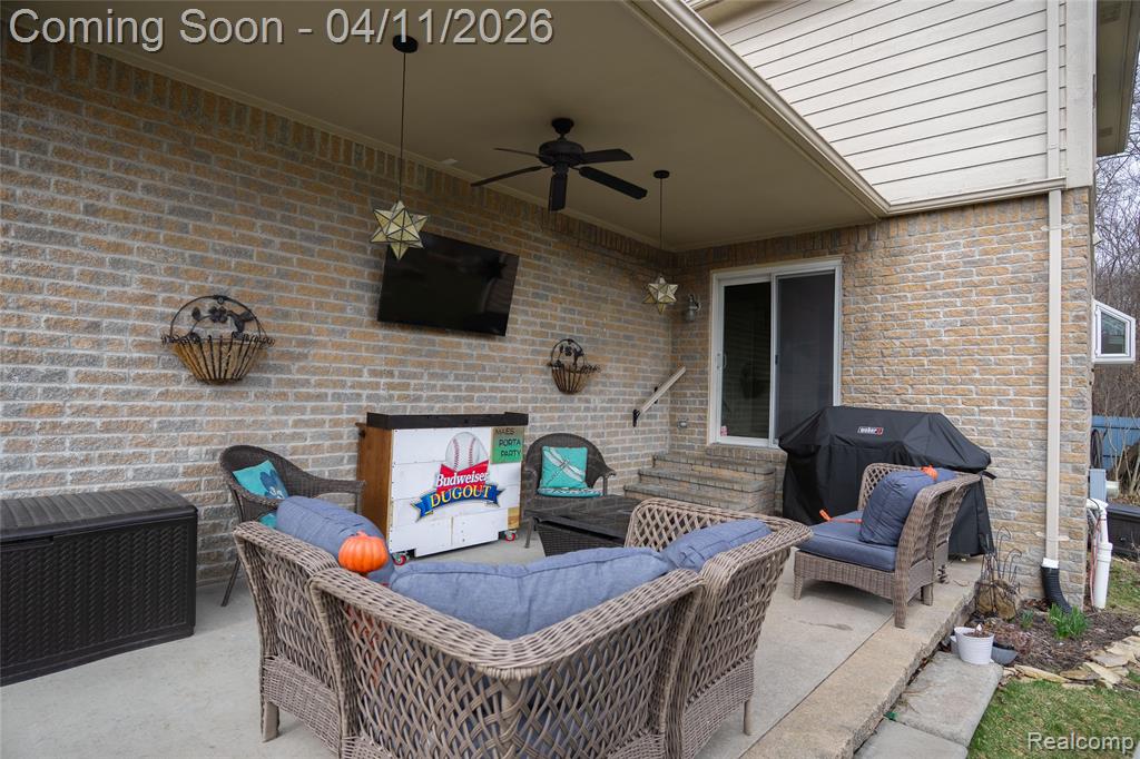View of patio / terrace featuring grilling area, ceiling fan, and an outdoor living space