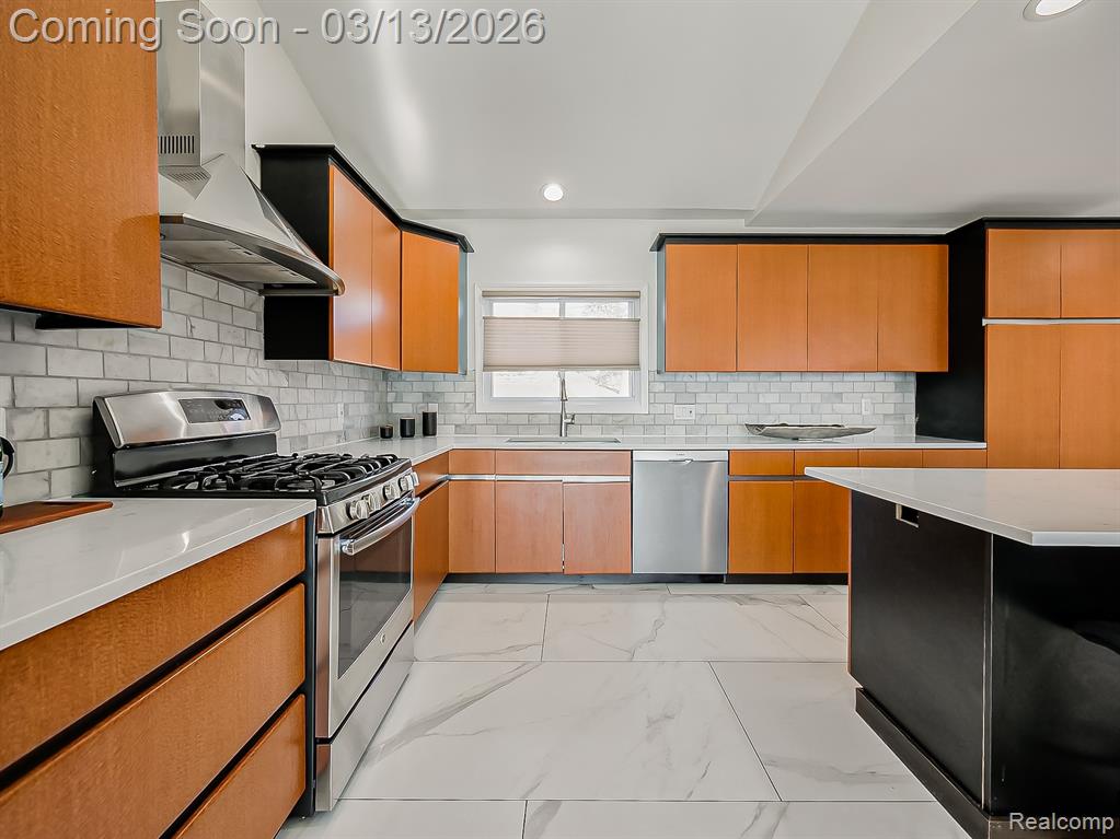 Dual tone kitchen featuring a center island, a kitchen breakfast bar, stainless steel dishwasher, light marble finish floors, and two tone color scheme